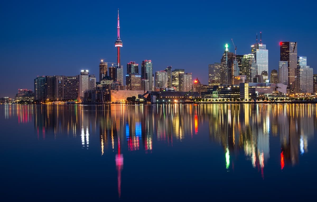 Toronto skyline at night with CN Tower reflected in the water