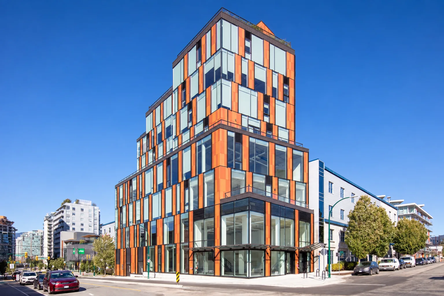 The building at 107 E 3rd Ave, Vancouver, by day and at night; Another Studios is the glass corner on the ground floor
