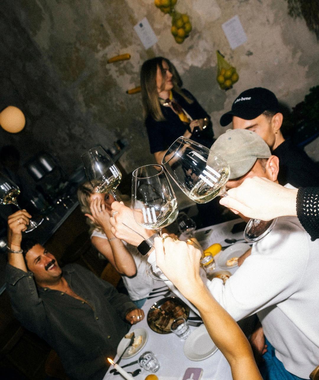Founders raising glasses together at a Founder Feast dinner